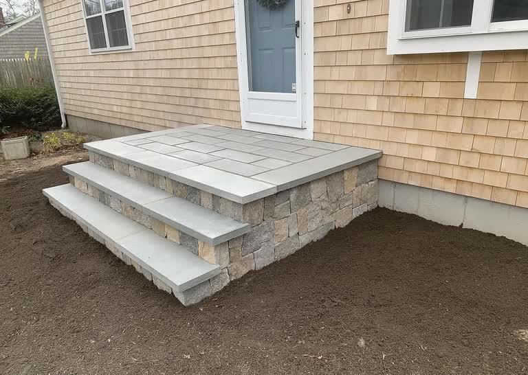 Bluestone entry steps and landing with natural-stone-faced risers