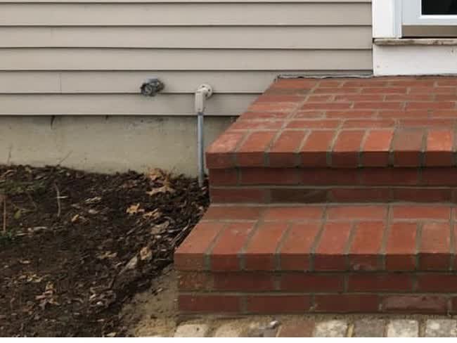 Close view of straight red-brick entry steps